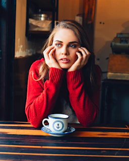 woman sitting in front of teacup