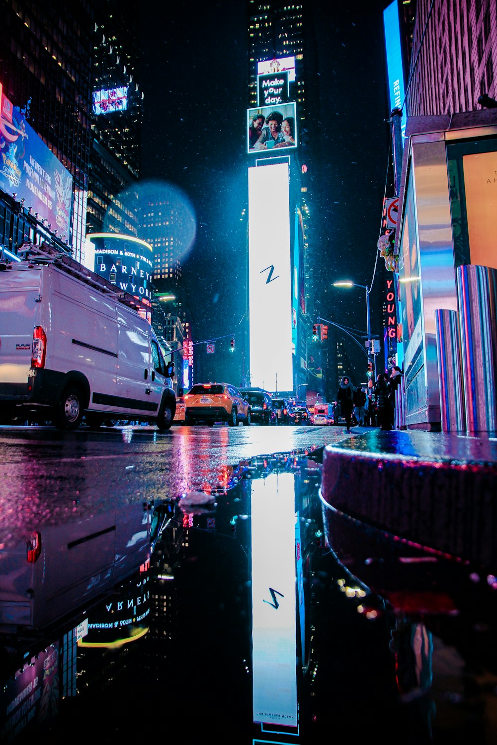 a city street at night with tall buildings