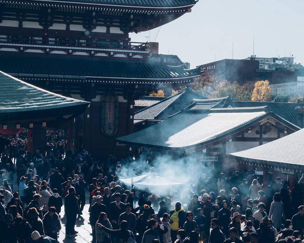 a crowd of people standing around a building