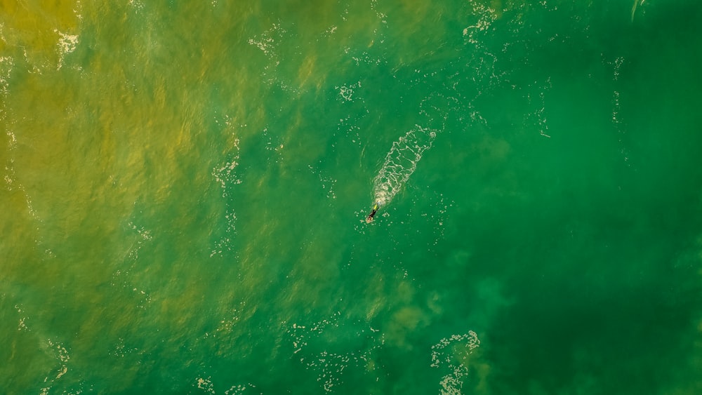 a person riding a surfboard on a wave in the ocean