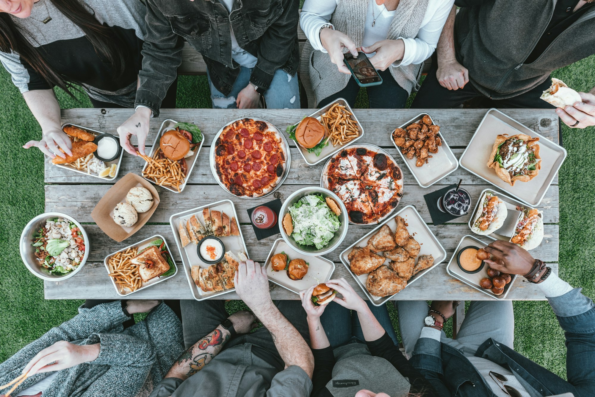 A long table from above, covered in shared plates.