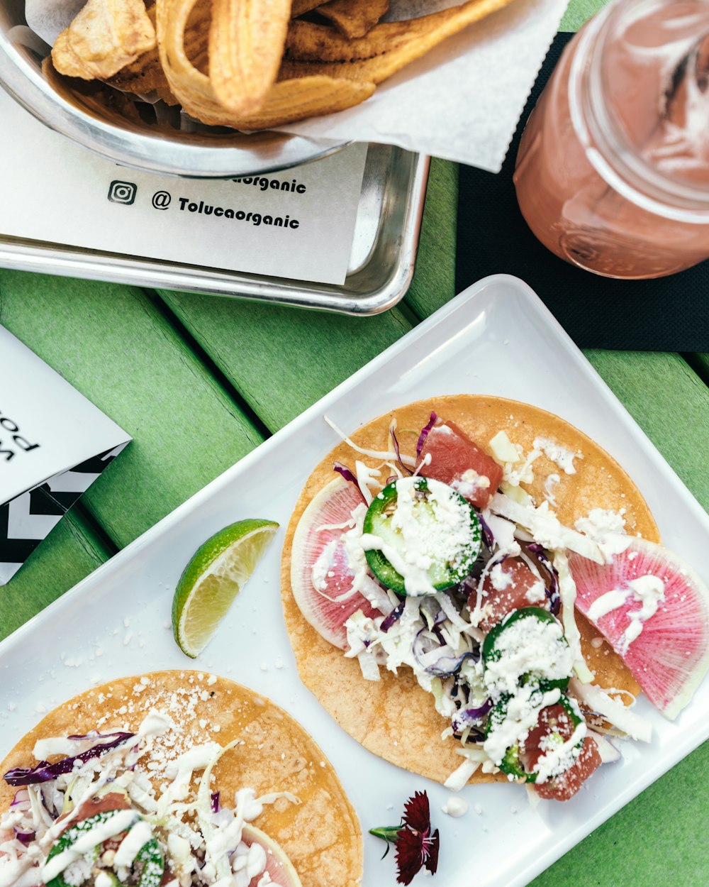 a couple of tacos sitting on top of a white plate