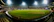 A vibrant photo of a college cricket tournament in progress with players and spectators energized under stadium lights.