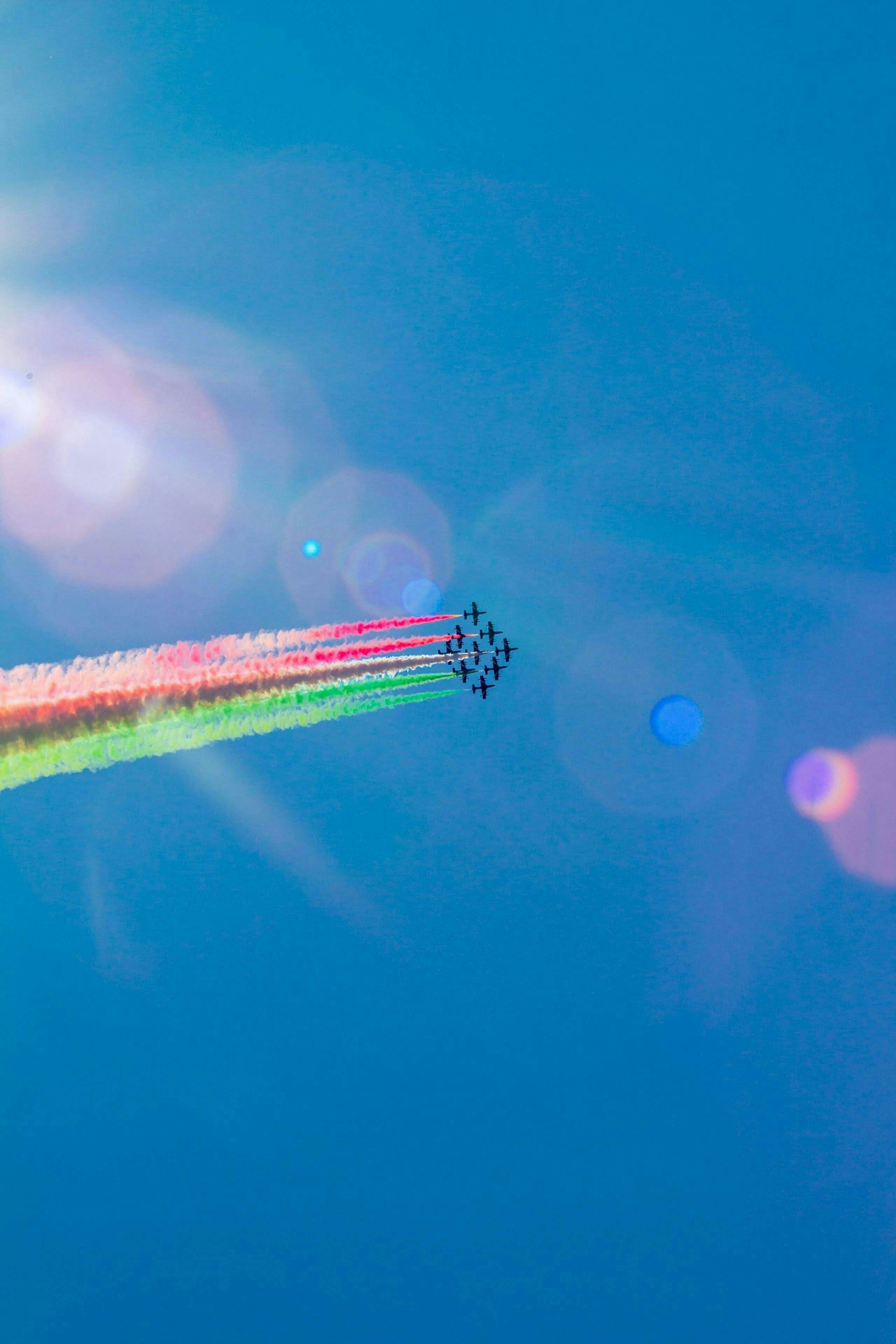 jet planes flying with assorted colored contrails