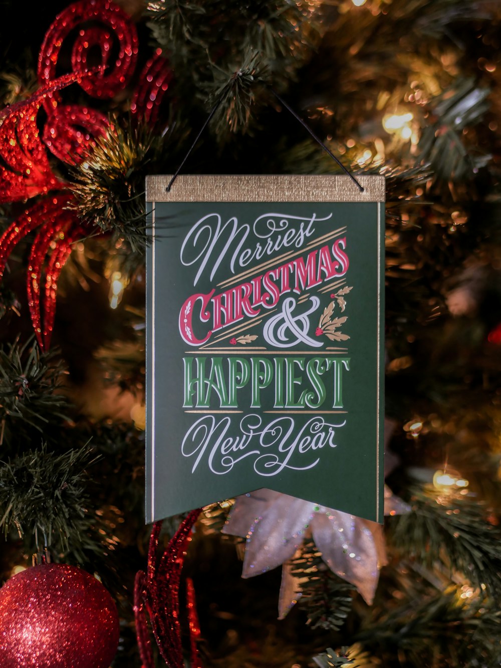 selective focus photography of Merriest Christmas & Happiest New Year sign