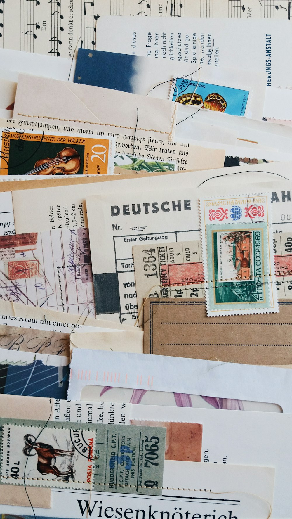 a pile of mail sitting on top of a sheet of paper