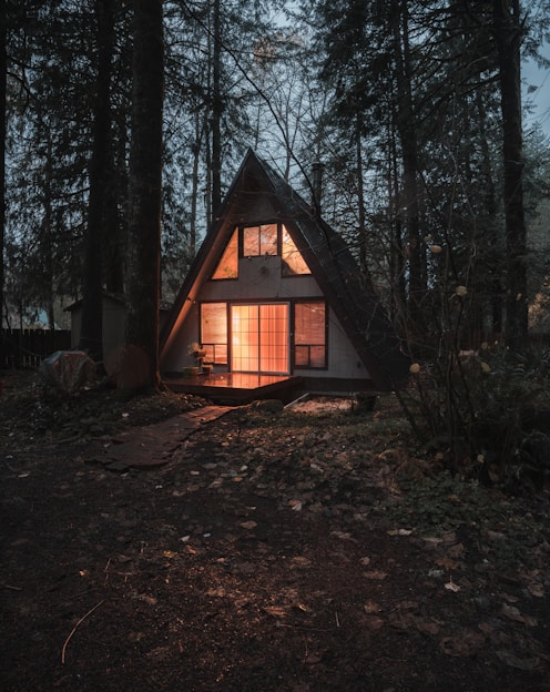 Cottage with warm light in the woods