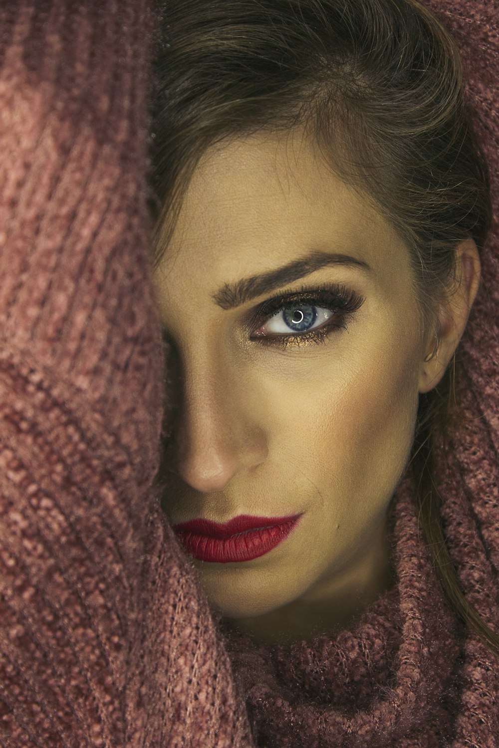 selective focus photography of woman wearing pink sweater