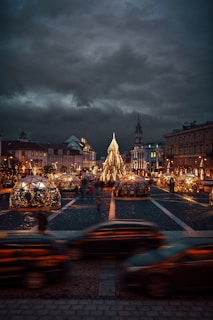 a city street with a christmas tree in the middle of it