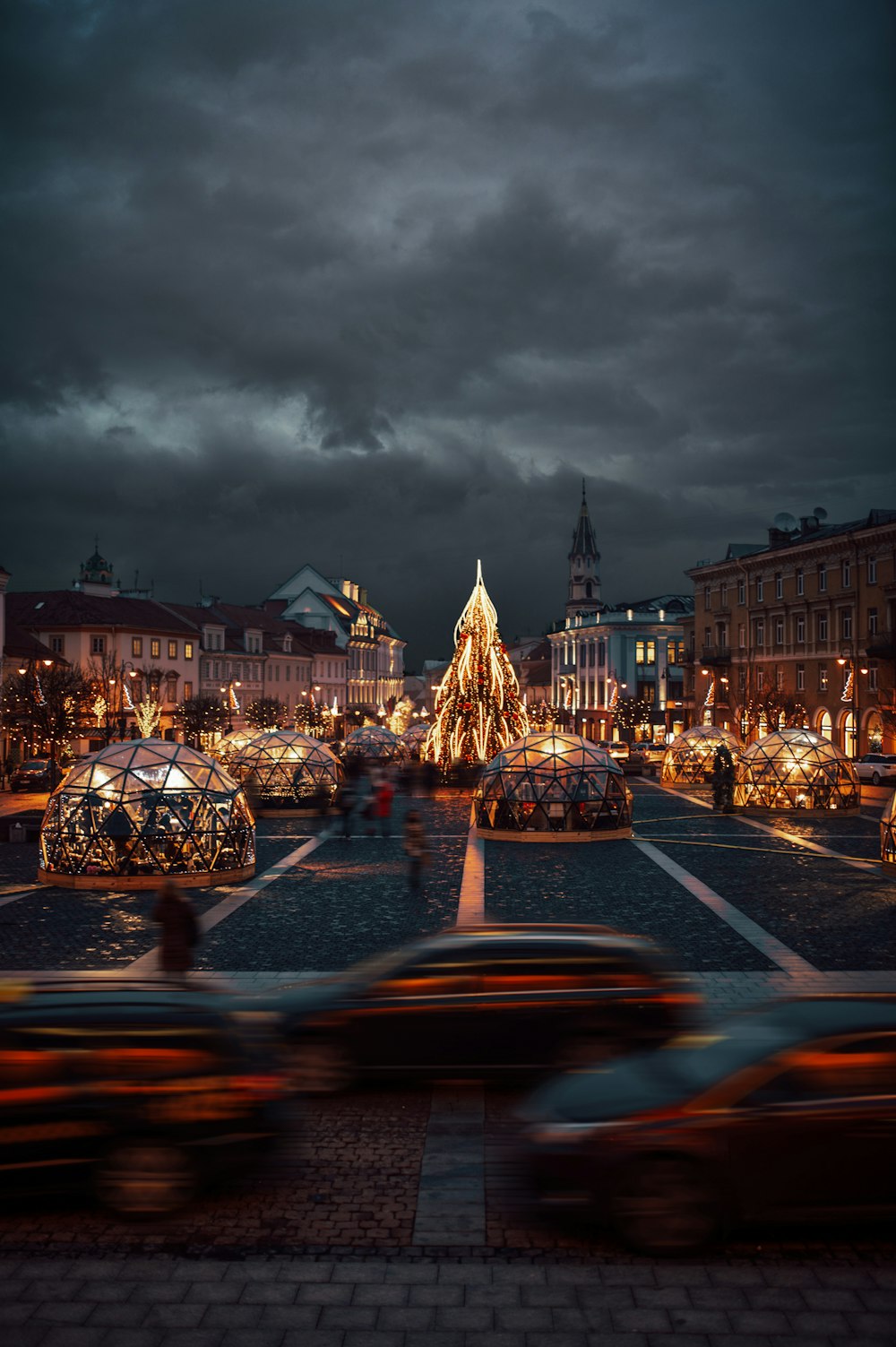 a city street with a christmas tree in the middle of it