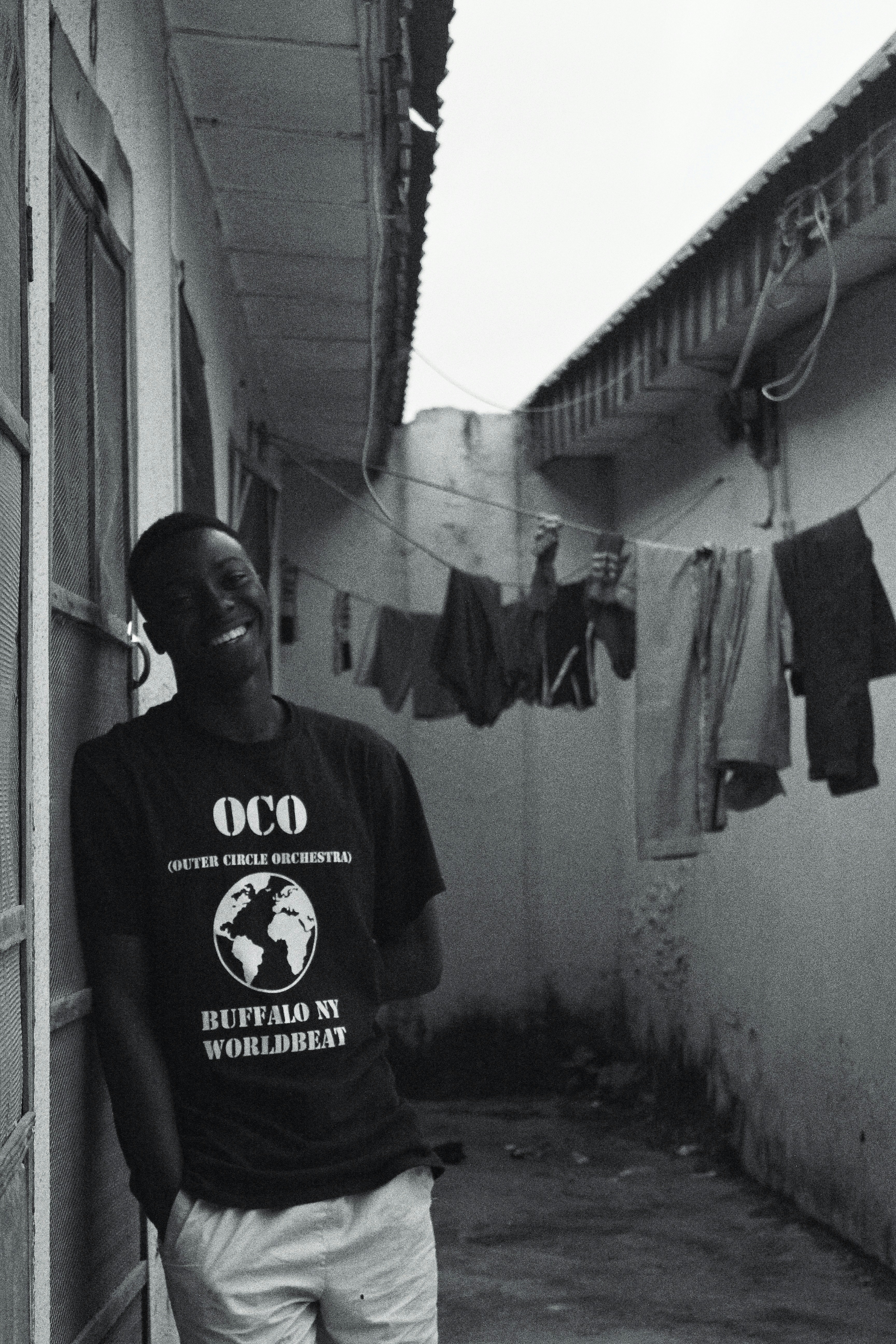 A teenager leaning on a door