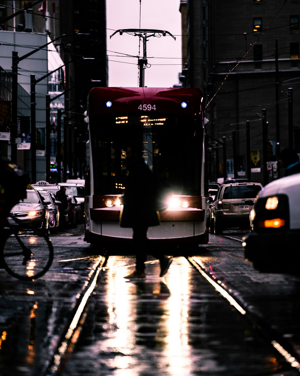 a city bus driving down a rain soaked street