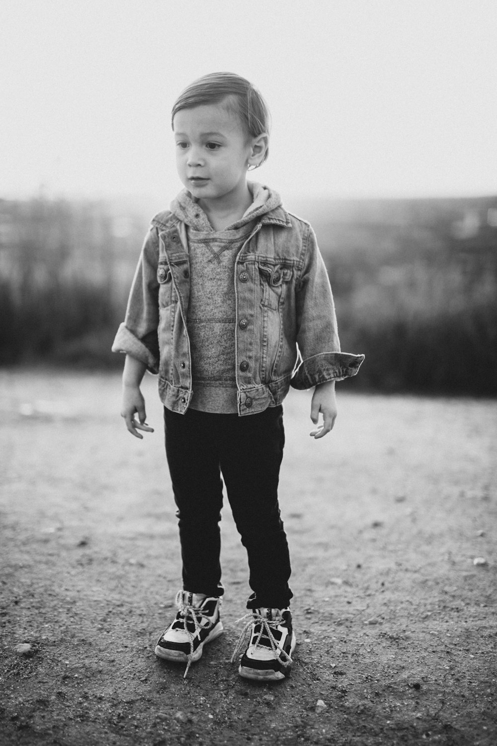 a little boy that is standing in the dirt