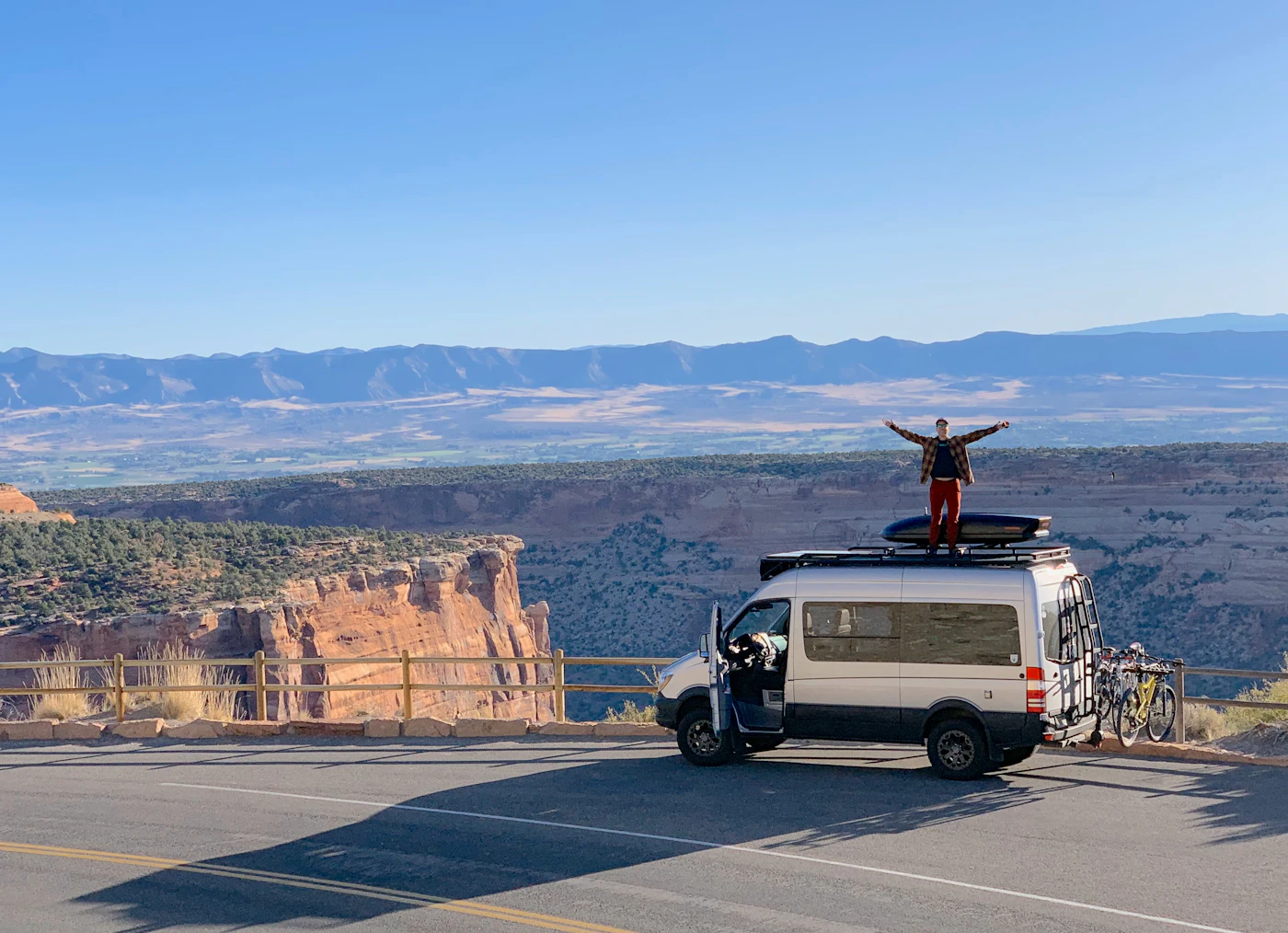 A man standing on the roof of a van