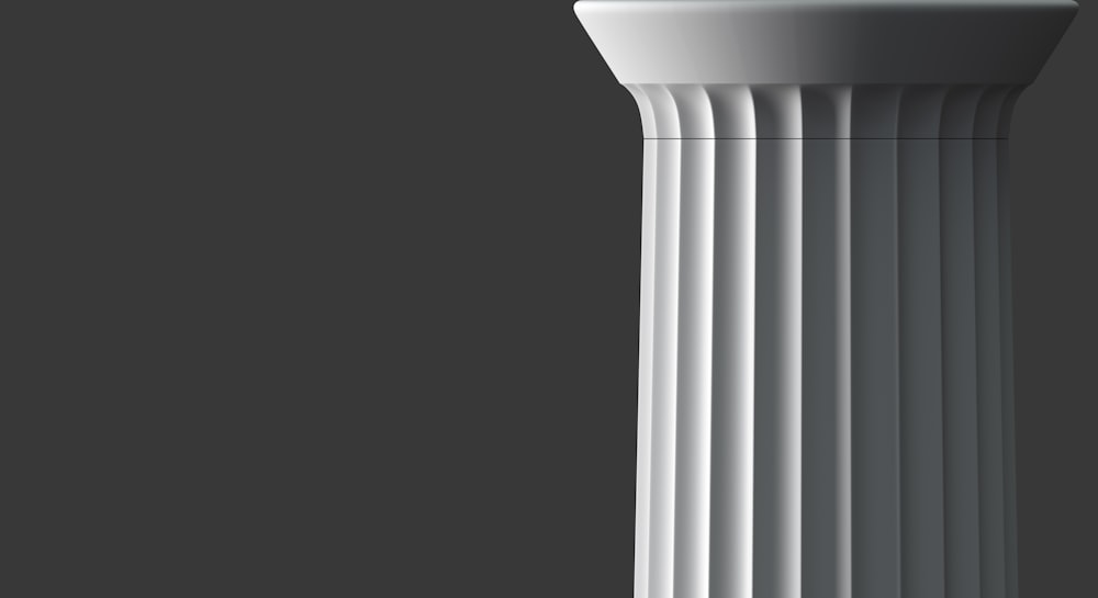 a tall white pillar with a black background