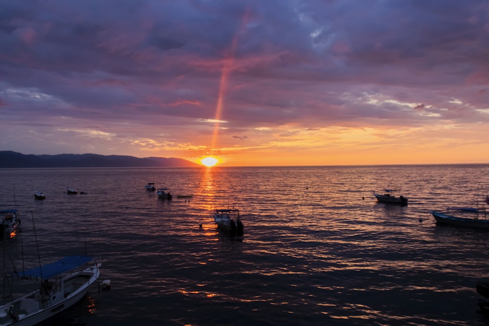 a group of boats floating on top of a body of water