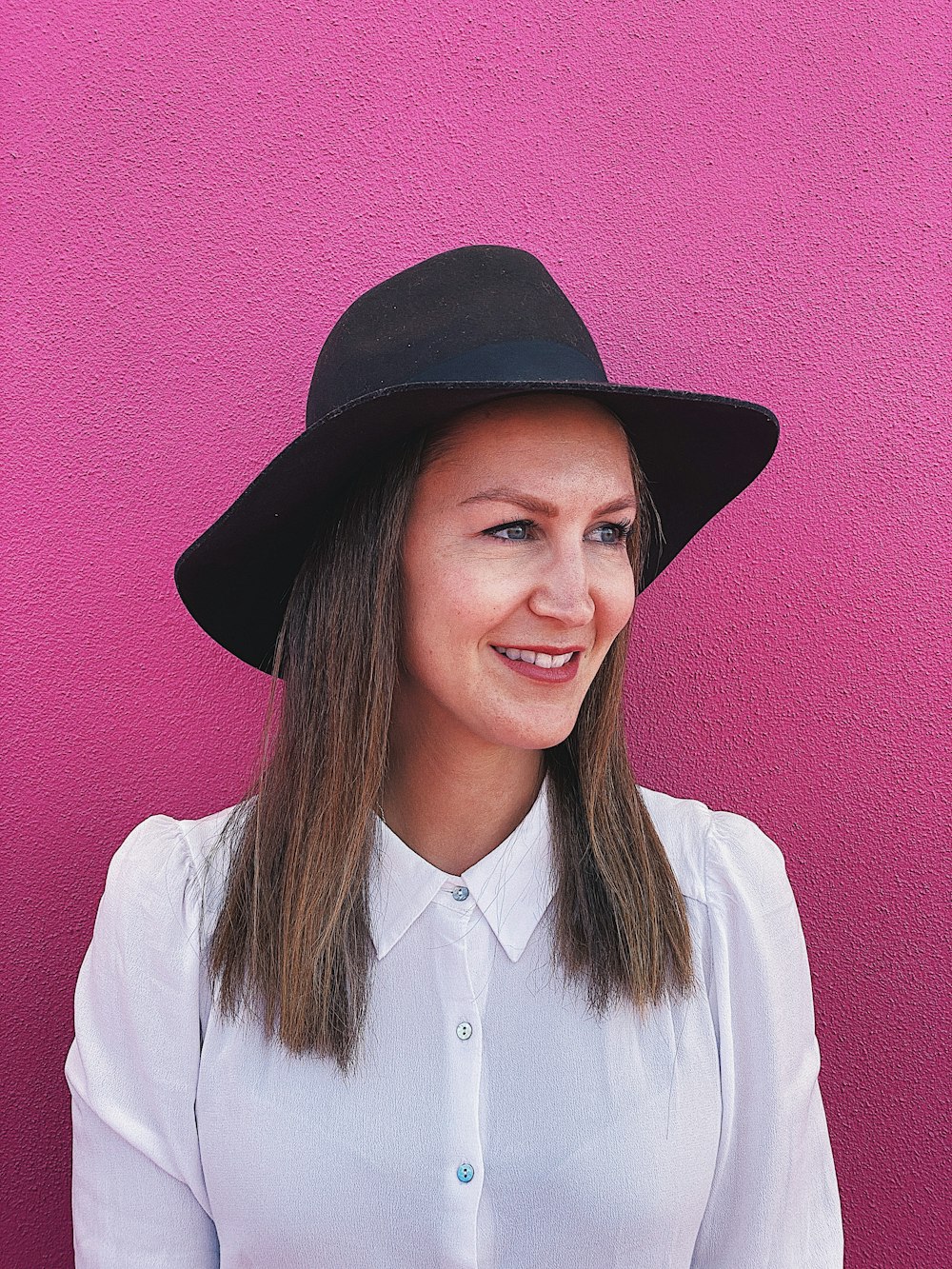 smiling woman wearing black hat