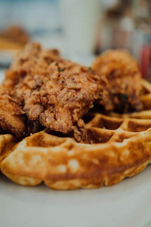 A plate of fried chicken and waffles, the kind of Southern breakfast dish Gritz Cafe is known for in the Historic Westside