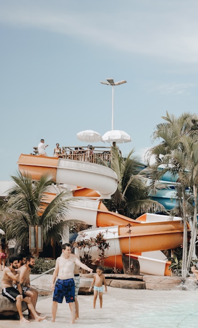 Water park with colorful slides and people enjoying summer water fun