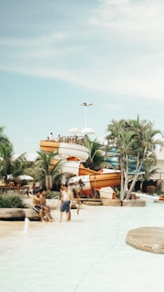 Families enjoying a sunny day at the water park.