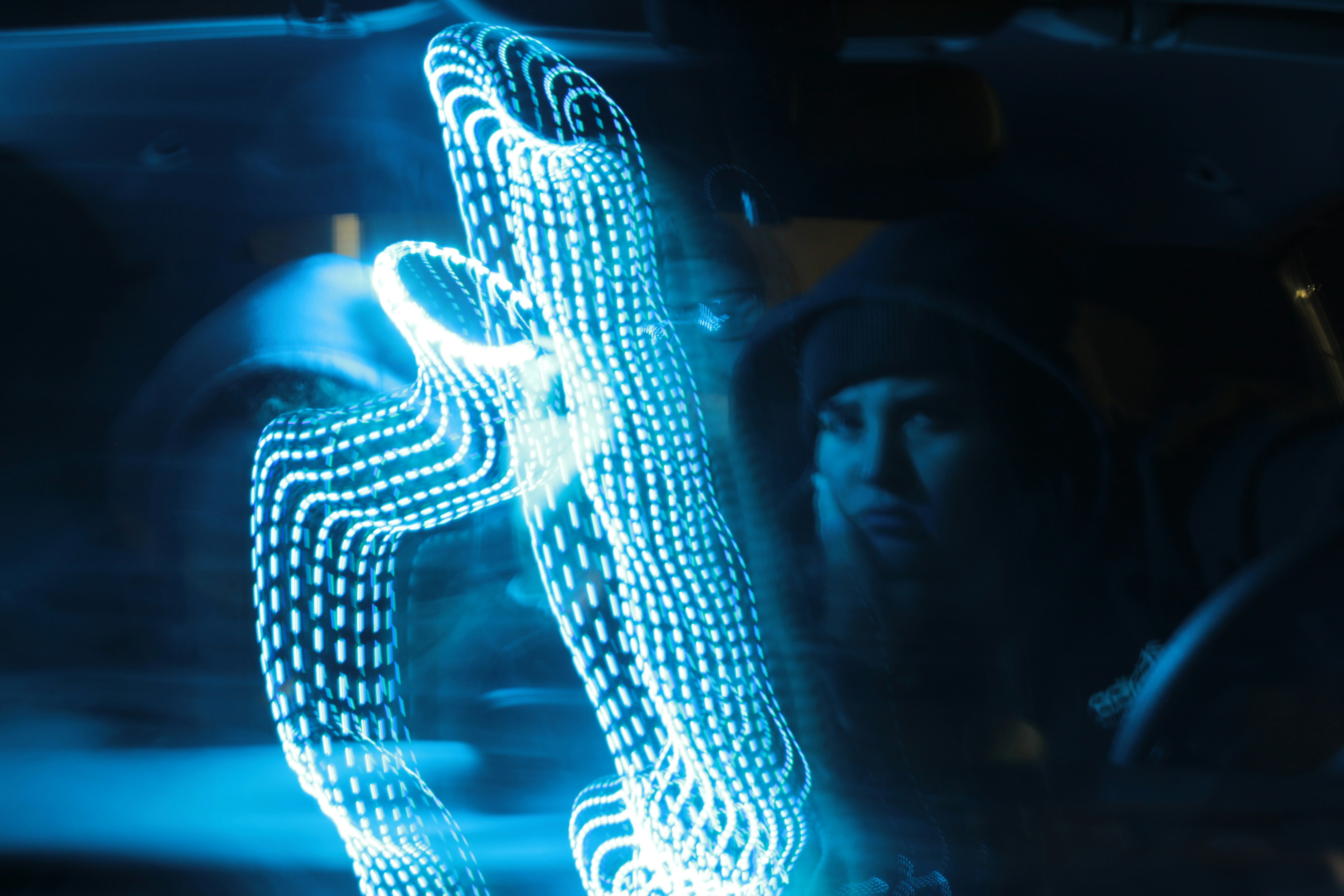 A close-up of a person's hands interacting with a floating, glowing holographic user interface, symbolizing a futuristic digital experience.