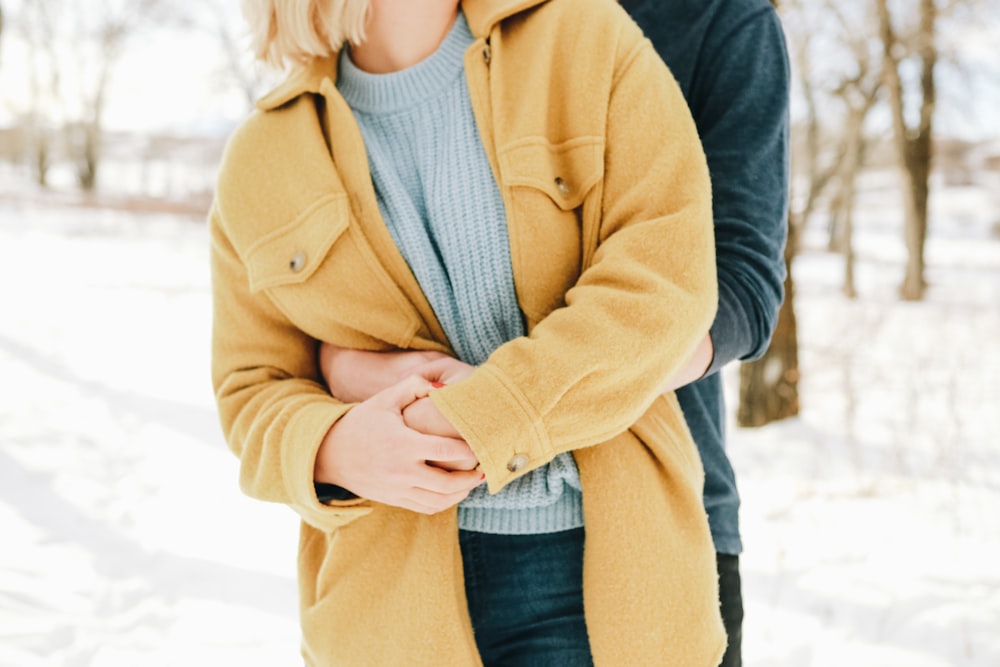 man hugging woman