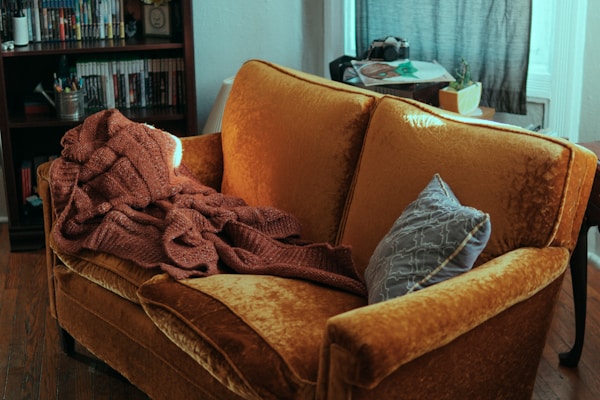 blanket and pillow on sofa