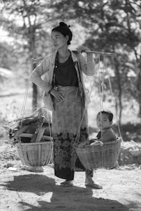 woman carrying basket with child and woods