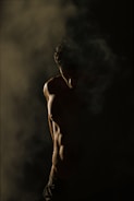 standing man in dim room