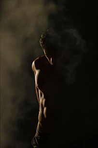 standing man in dim room