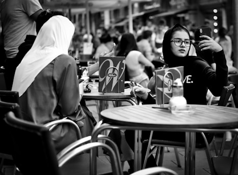 A candid shot of a lively travel collaboration in a sunlit café, capturing vibrant moments between the creator and brand partners.