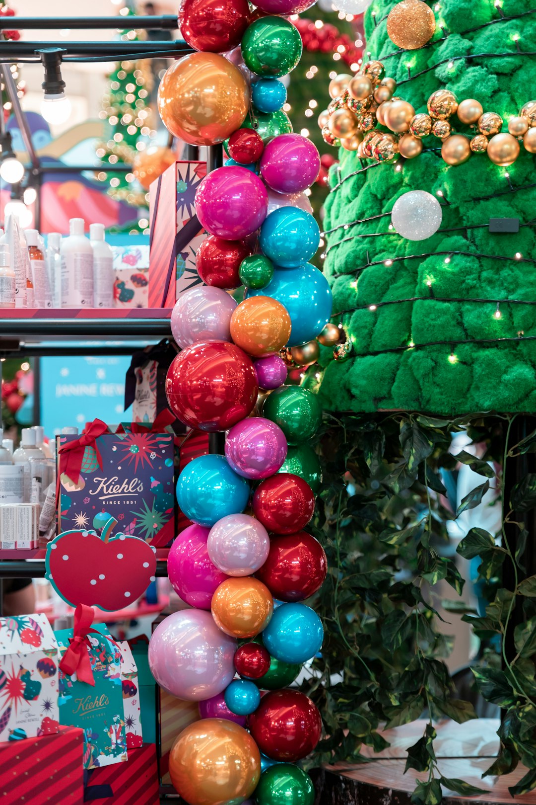 assorted-color Christmas bauble decor beside display shelf
