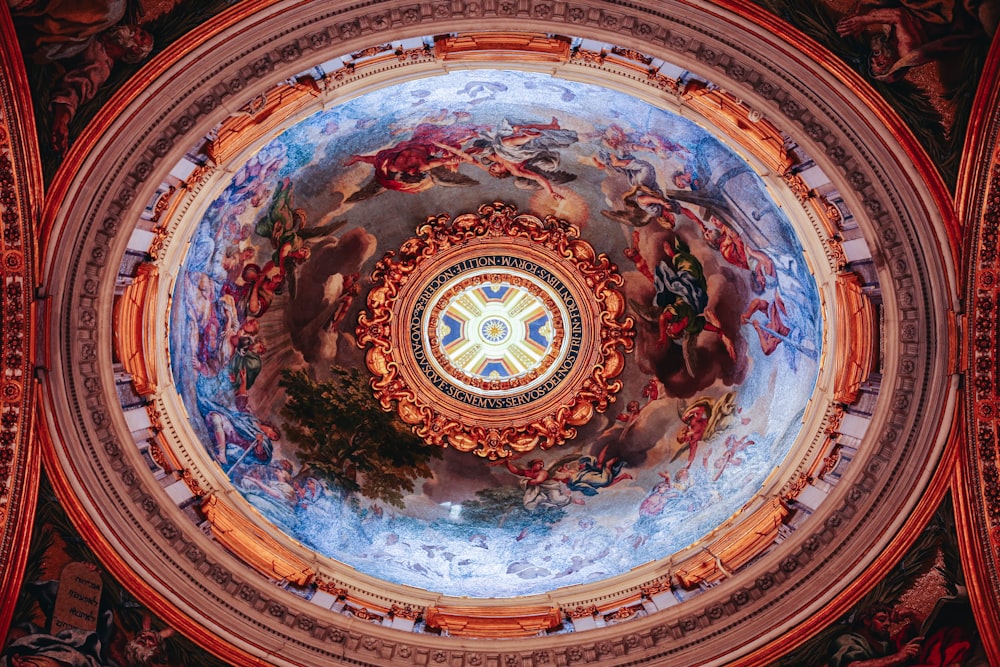 the ceiling of a building with a painting on it