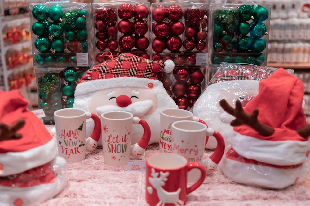 five white-and-red ceramic mugs