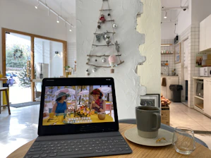 A cozy restaurant interior with a digital tablet showing a custom website design.