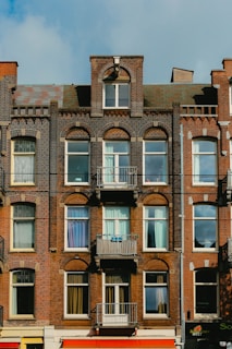 A charming downtown apartment building with classic brick architecture and large windows.