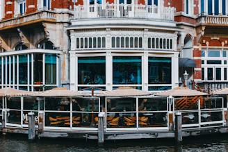 Cozy old mansion converted into a vibrant seafood restaurant with outdoor brewery seating on a sunny day