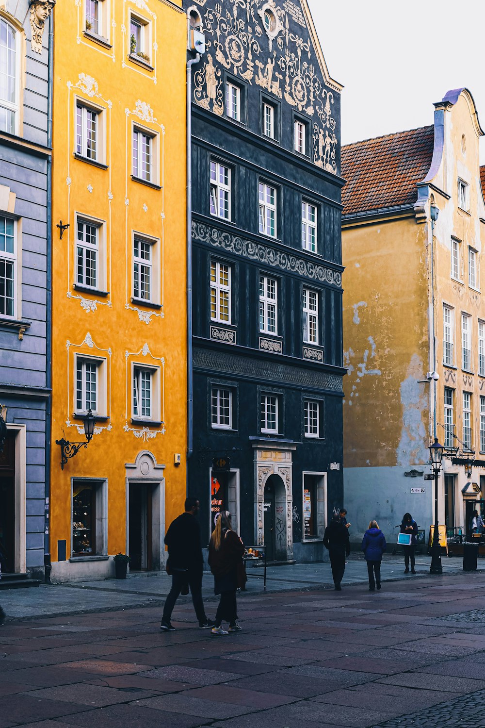 people walking beside building during daytime