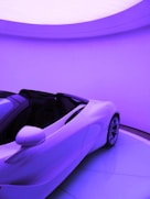 parked white convertible coupe inside building
