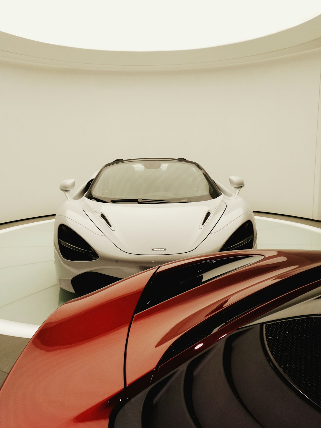 two white and red cars parked indoors