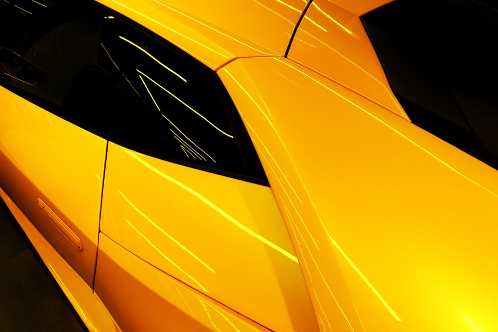 a close up of the hood of a yellow sports car