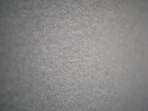 Close-up of a modern textile pattern with soft, neutral tones and subtle textures.