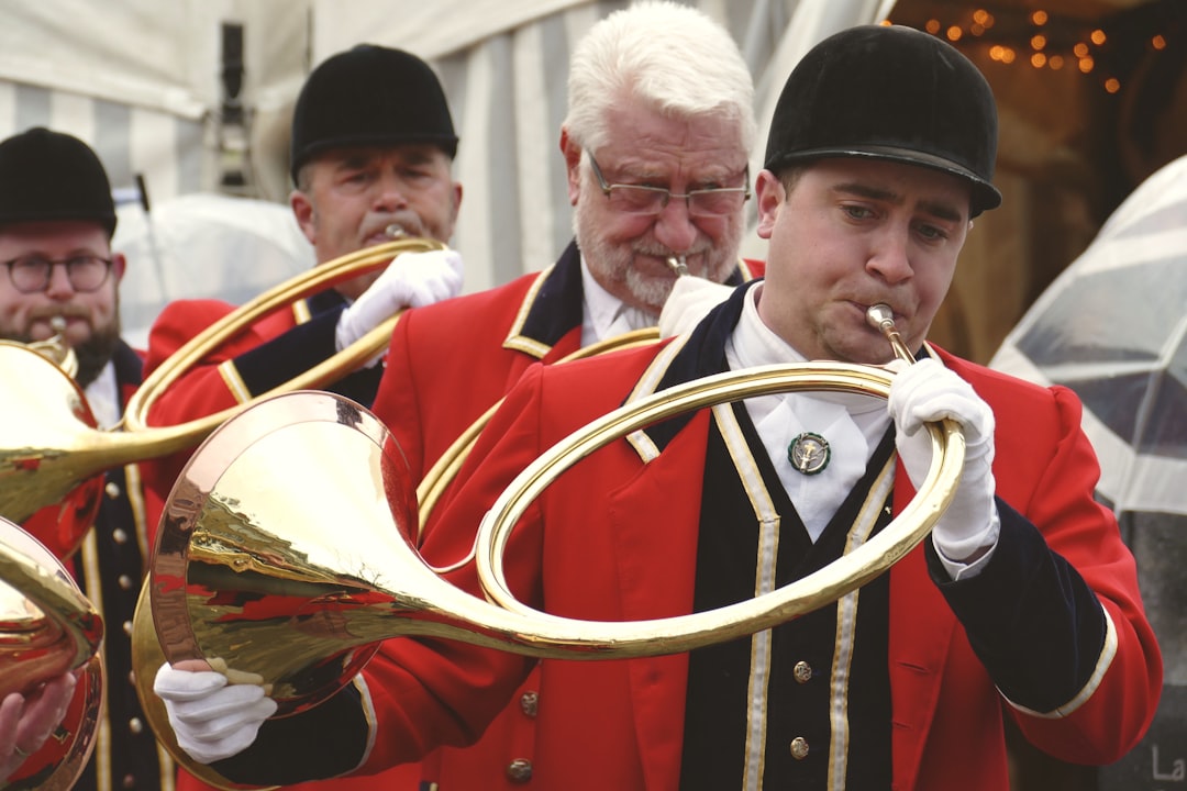 photography of men playing wind musical instrument