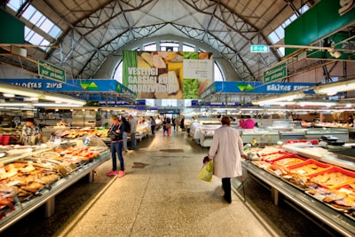 a woman is walking through a grocery store