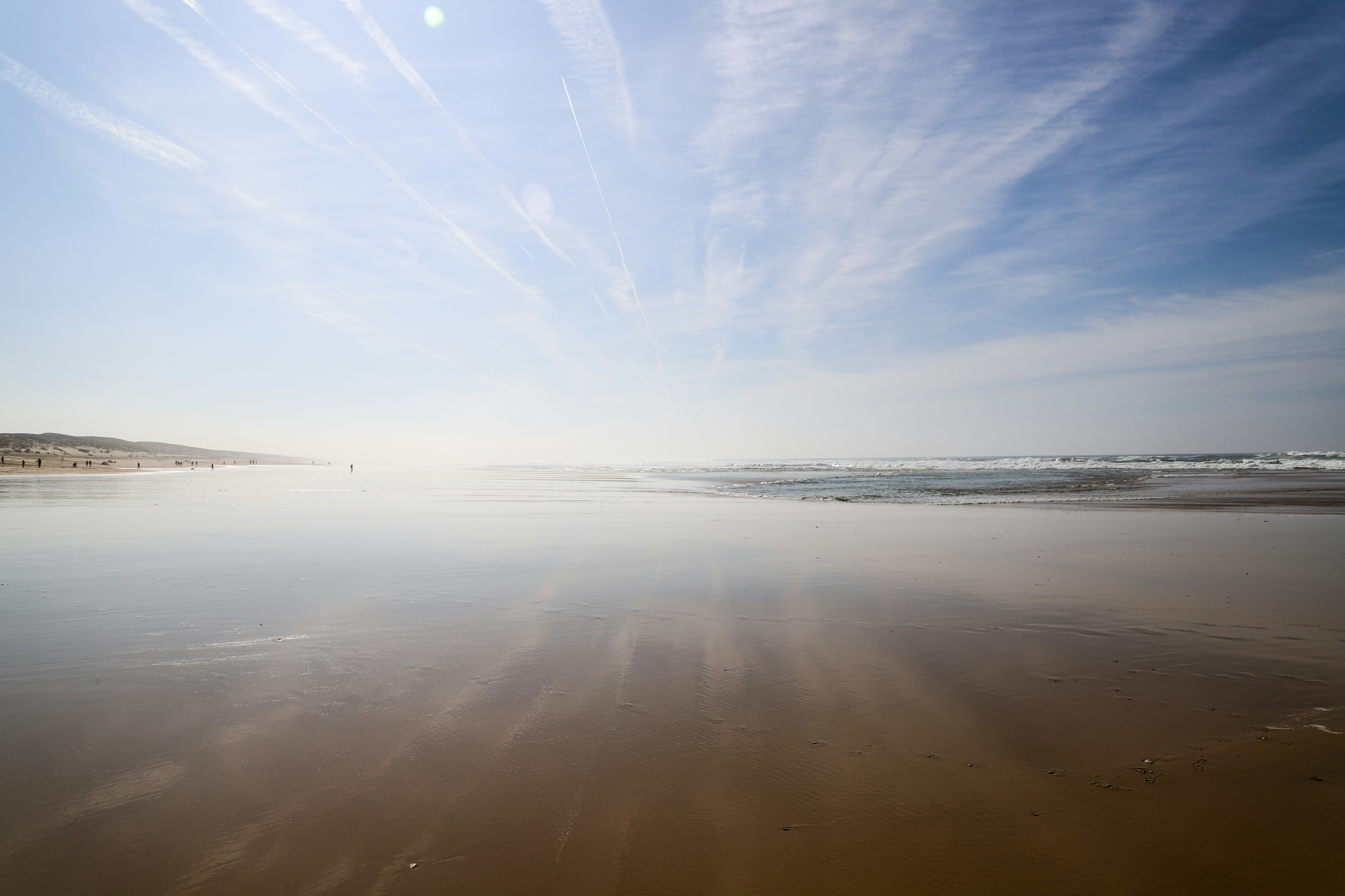 the sun is shining down on the beach
