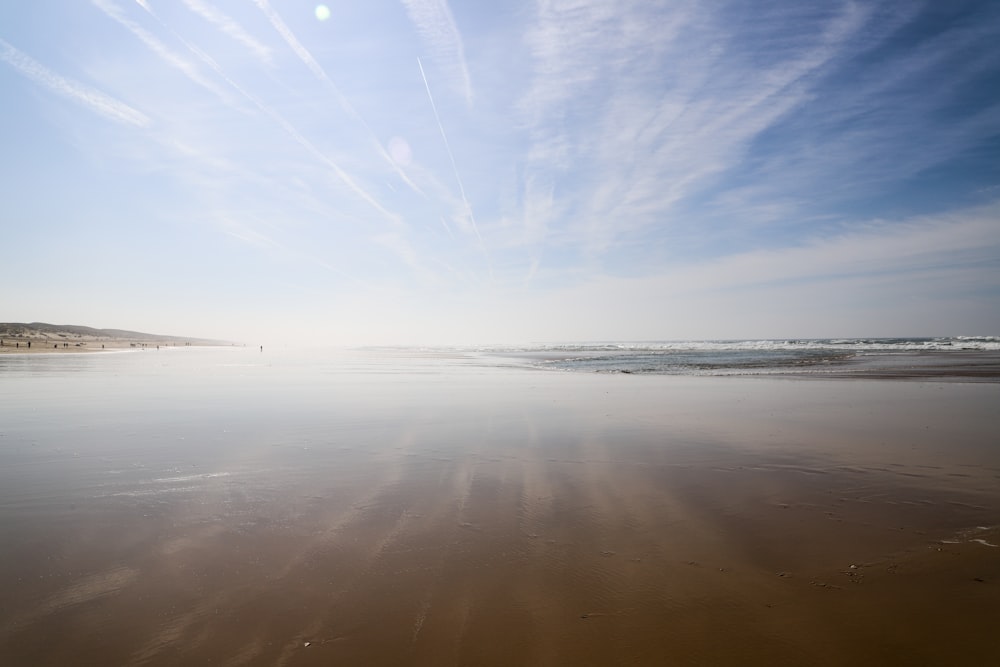 the sun is shining down on the beach