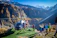 A happy family boarding a helicopter with scenic Himalayan mountains in the background.
