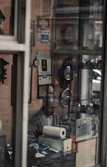 A friendly small business owner reviewing paperwork with a calm, focused expression in a cozy office.