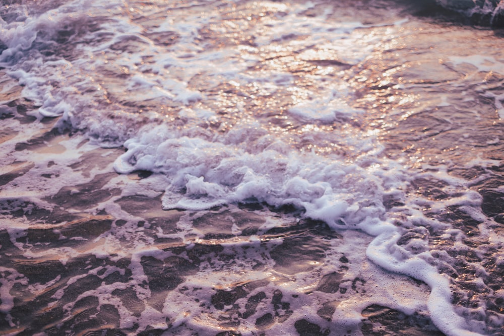 a close up of a wave on a beach