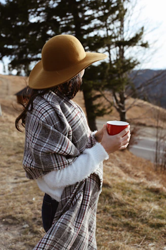woman holding red mug